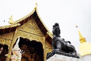 Heritage Golden and white sanctuary and chapel in the temple of lanna style at Chiangmai province, Thailand photo