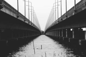 Perspective Black and white of concrete Bridge over the Songkhla lake in Thailand photo
