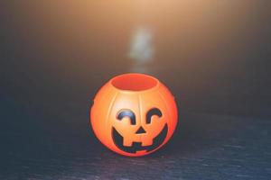 Halloween pumpkin head with golden light in dark night bakckground. Halloween holiday concept. photo