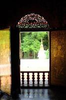 Beautiful light and shadow of Golden Thai art carved wood on the old wooden door at Wat Pa Dara Phirom Phra Chulamani Si Borommathat temple at Chiangmai province, Thailand. photo