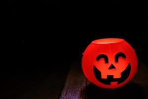 Halloween pumpkin head with golden light in dark night bakckground. Halloween holiday concept. photo