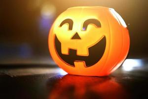 Halloween pumpkin head with golden light in dark night bakckground. Halloween holiday concept. photo