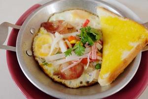 Indochina pan fried egg with topping in homemade and butter Toast easy breakfast in Thailand.. photo