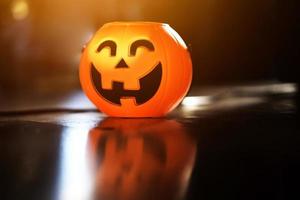 Halloween pumpkin head with golden light in dark night bakckground. Halloween holiday concept. photo