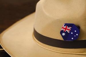 Anzac army slouch hat with Australian Flag on vintage wood background photo