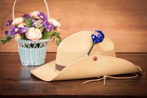 Anzac army slouch hat with Australian Flag on vintage wood background photo