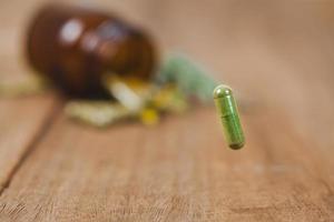 Herbal medicine capsule from herb on blur background .soft focus. photo