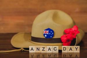 Anzac army slouch hat with Australian Flag on vintage wood background photo