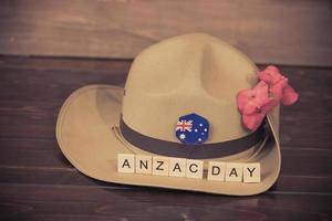 Anzac army slouch hat with Australian Flag on vintage wood background photo