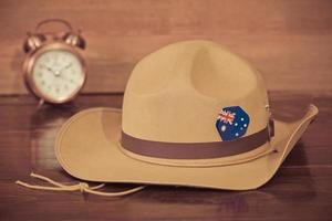 Anzac army slouch hat with Australian Flag on vintage wood background photo