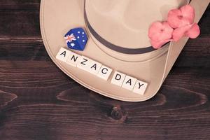 Anzac army slouch hat with Australian Flag on vintage wood background photo