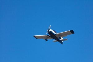 White and blue civil aircraft in mid air photo