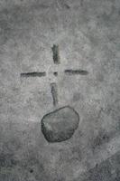 Orb and cross symbol carved on stone photo