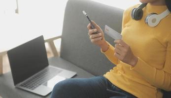 Close up of woman hand using credit card and laptop for payment and online shopping, Online shopping, payments digital banking, E-commerce concept. photo