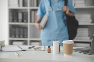 Healthcare and medical concept. Medicine doctor with stethoscope in hand and Patients come to the hospital background. photo