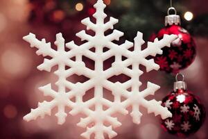 snowflake ornament hanging from a christmas tree. . photo