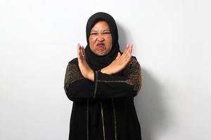 Angry Middle aged Asian women wearing hijab crossed her arms, saying no and expressing rejection gesture photo