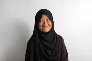 Young Asian girl wearing hijab thinking about creative and crazy ideas isolated on white background. photo