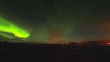 Beautiful aurora borealis over Geysir hot springs landmark in Iceland with eruptions video