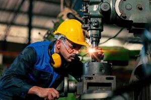 An expert male engineer or worker is working in an industrial plant. Workers work confidently. photo