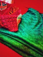 A green blanket on a red chair. photo