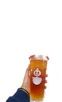 Bekasi, Indonesia in March 2023. Isolated white photo of a hand holding a cup of jasmine Mixue tea.