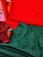 A green blanket on a red chair. photo