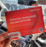 Jakarta, Indonesia in March 2023. A hand is holding a box and a card from a modem with the product Orbit Star Z1 photo