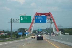 Central Java, Indonesia in April 2023. Cars will cross the Kalikuto bridge photo