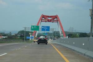 Central Java, Indonesia in April 2023. Cars will cross the Kalikuto bridge photo