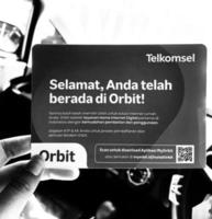 Jakarta, Indonesia in March 2023. A hand is holding a box and a card from a modem with the product Orbit Star Z1 photo