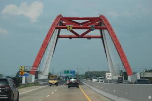 Central Java, Indonesia in April 2023. Cars will cross the Kalikuto bridge photo