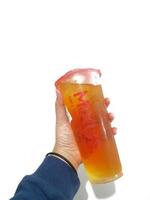 Bekasi, Indonesia in March 2023. Isolated white photo of a hand holding a cup of jasmine Mixue tea.