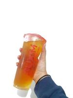 Bekasi, Indonesia in March 2023. Isolated white photo of a hand holding a cup of jasmine Mixue tea.
