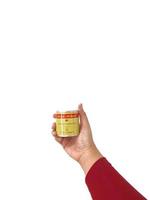 Bekasi, Indonesia in March 2023. Isolated white photo of a hand holding a can of Aica Aibon glue.