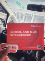 Jakarta, Indonesia in March 2023. A hand is holding a box and a card from a modem with the product Orbit Star Z1 photo