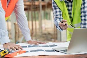 Engineers team use laptop and check the blueprint on site. Contractor and inspector inspection construction during project.civil Forman check quality assurance. Audit, inspect, quality control. photo