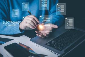 Signing electronic documents on digital documents Online and checklist and clipboard task documentation management,  working laptop checklist questionnaire assessment form, online survey online exam. photo