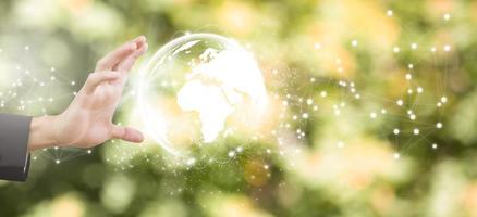 Concept Technology with line connects the world, Businessman holding hands with global connection on the nature background, global networking and global information exchange 3D rendering. photo