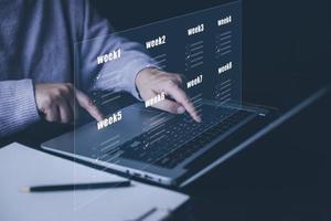 Businessman using a laptop and Taking an assessment, questionnaire, evaluation, online survey online exam Choosing the right answer in exam by filling out the online survey form,Answer  test questions photo