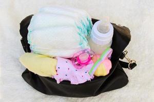 Women's handbag with items to care for the child photo