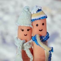 Finger art of a Happy couple on the background of snow. photo