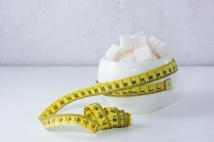 sugar bowl filled with sugar wrapped with measuring tape photo