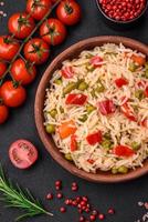 Delicious boiled rice with vegetables peppers, carrots, peas and asparagus beans photo