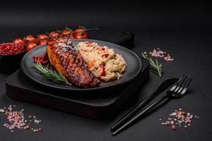 Delicious red salmon fish grilled with sauce and sesame seeds with rice and vegetables photo