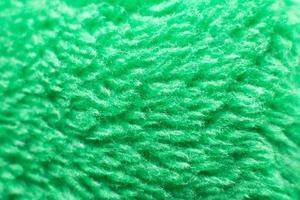 Green fluffy textile texture. Nappy hairy background closeup. photo