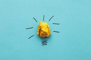 crumpled yelllow paper laightbulb as a concept creative idea and innovation photo