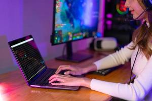 Woman playing online video game and trading on price chart digital stock exchange. broadcast streaming live at home. Gamer and E-Sport online gaming technology Championship tournament gamer concept. photo