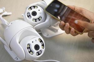 White IP camera, technician setting up camera operation photo