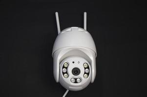 White IP camera over a black background photo